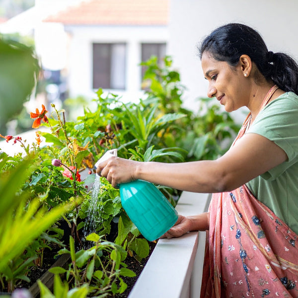 Woman watering plants in a garden